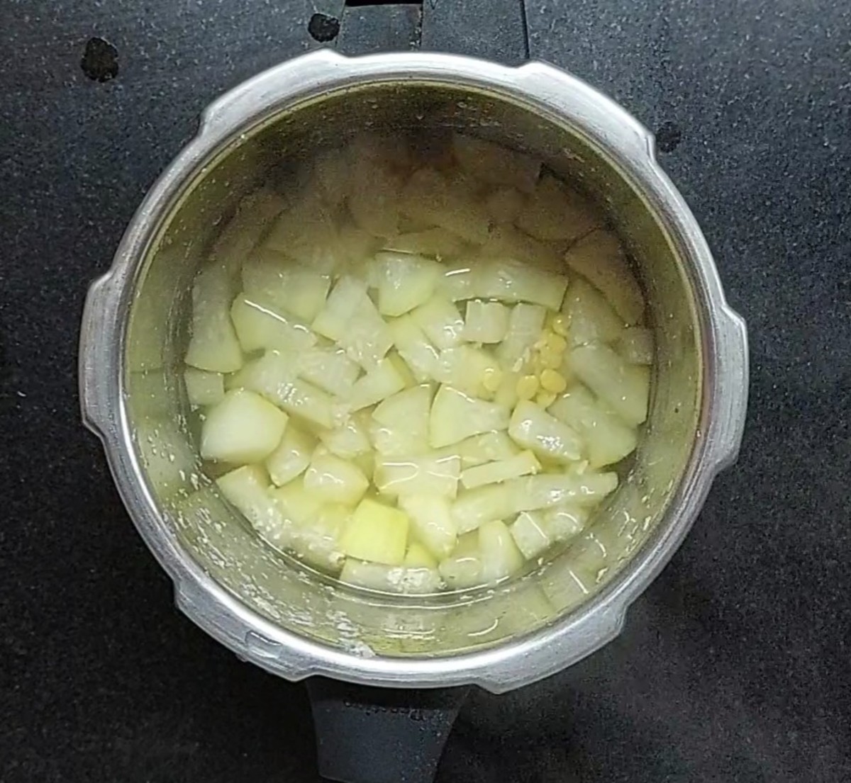 Once pressure of the cooker releases, open and check if dal and bottle gourd cooked properly.