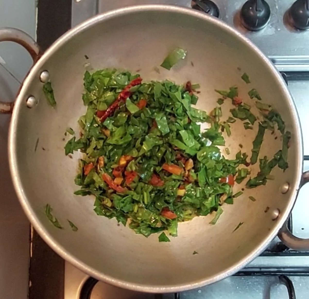 Add 1 cup washed and chopped palak leaves with tender stems, saute till palak shrinks.