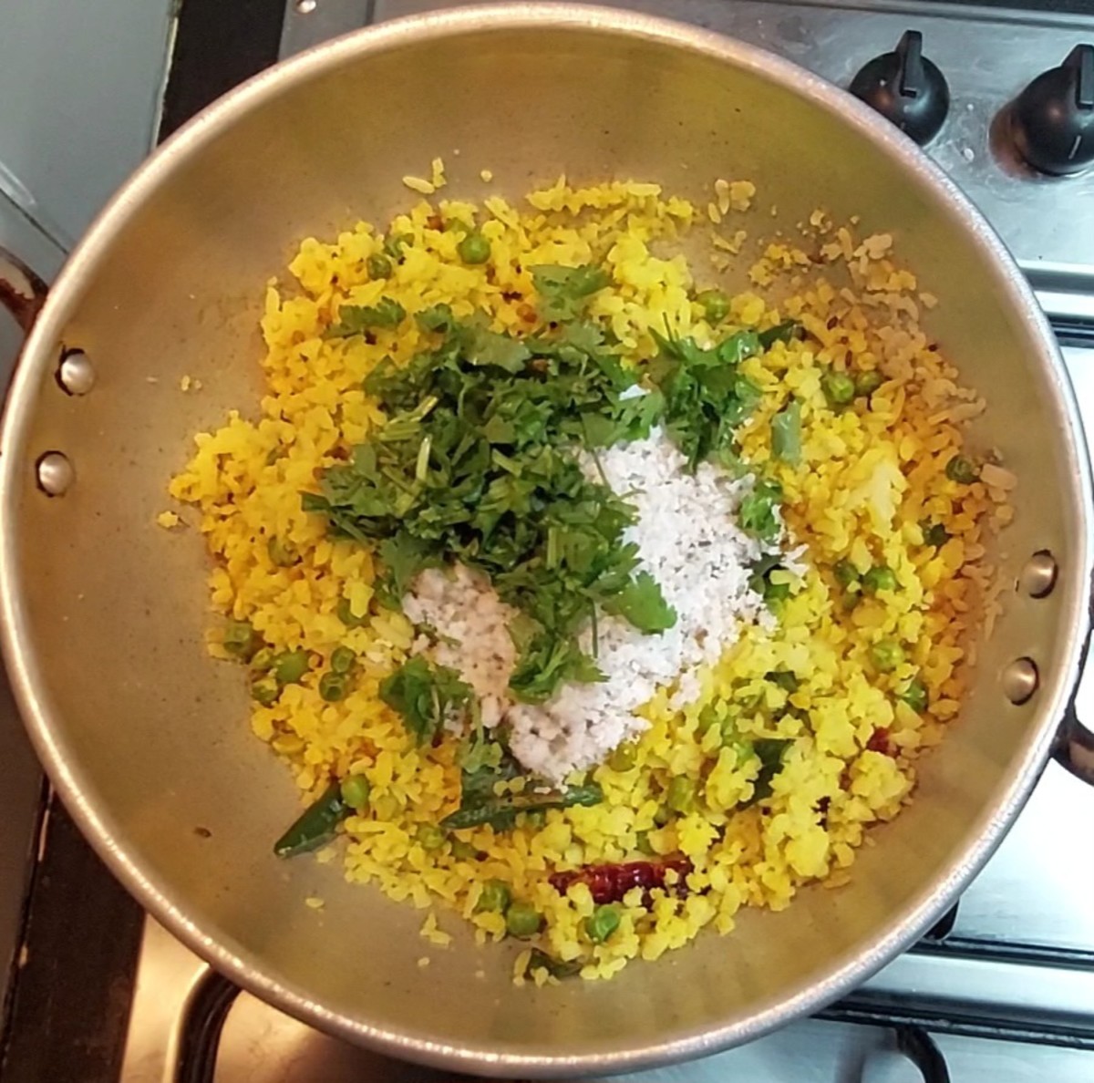 Add 1/2 cup fresh grated coconut, 1/4 cup chopped coriander leaves, mix well.