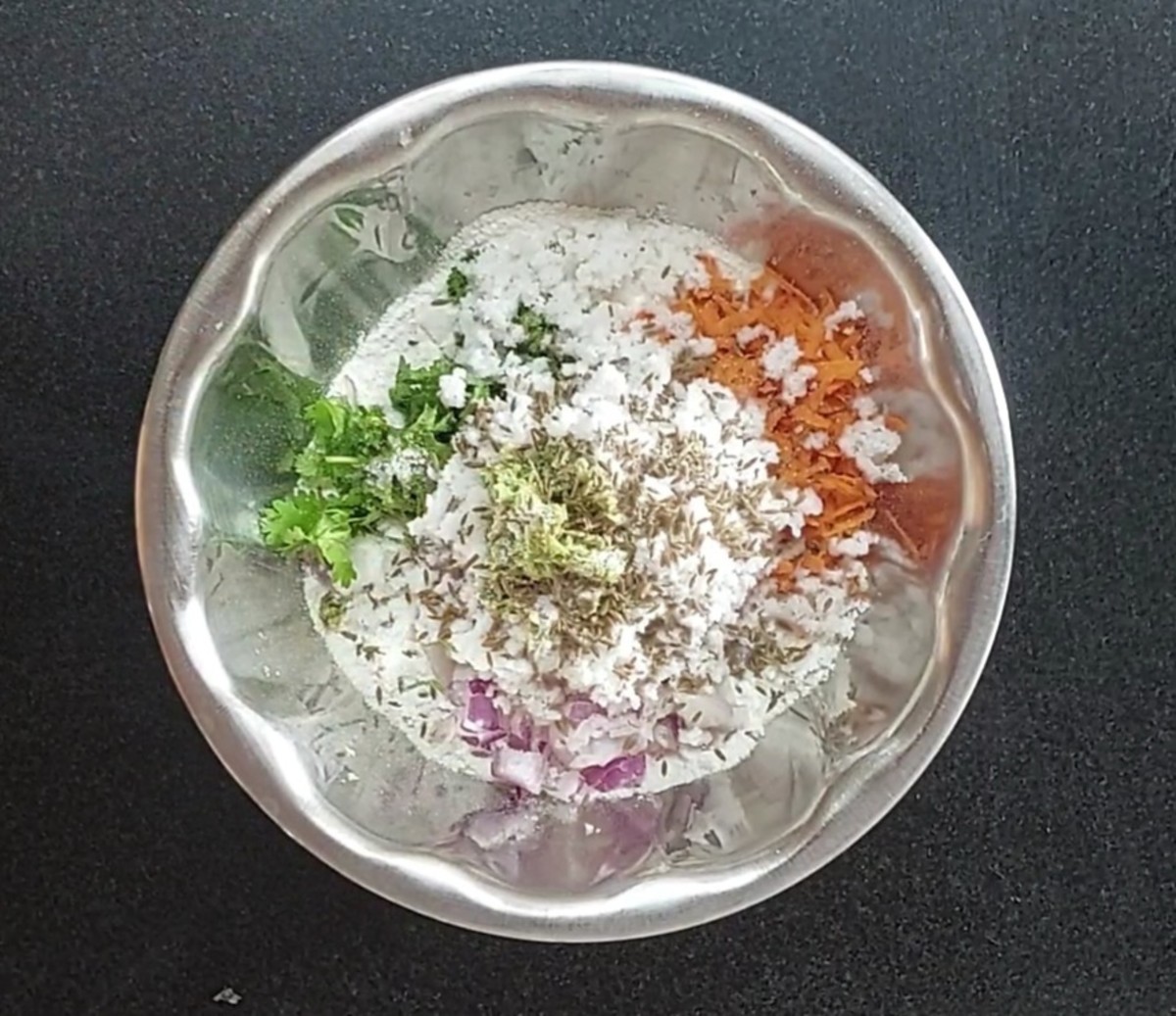 add 1 finely chopped onion, 1 grated carrot, 1/4 cup chopped coriander leaves, 3/4 cup fresh grated coconut, 1 teaspoon ginger-green chili paste, 1 teaspoon cumin seeds, salt.