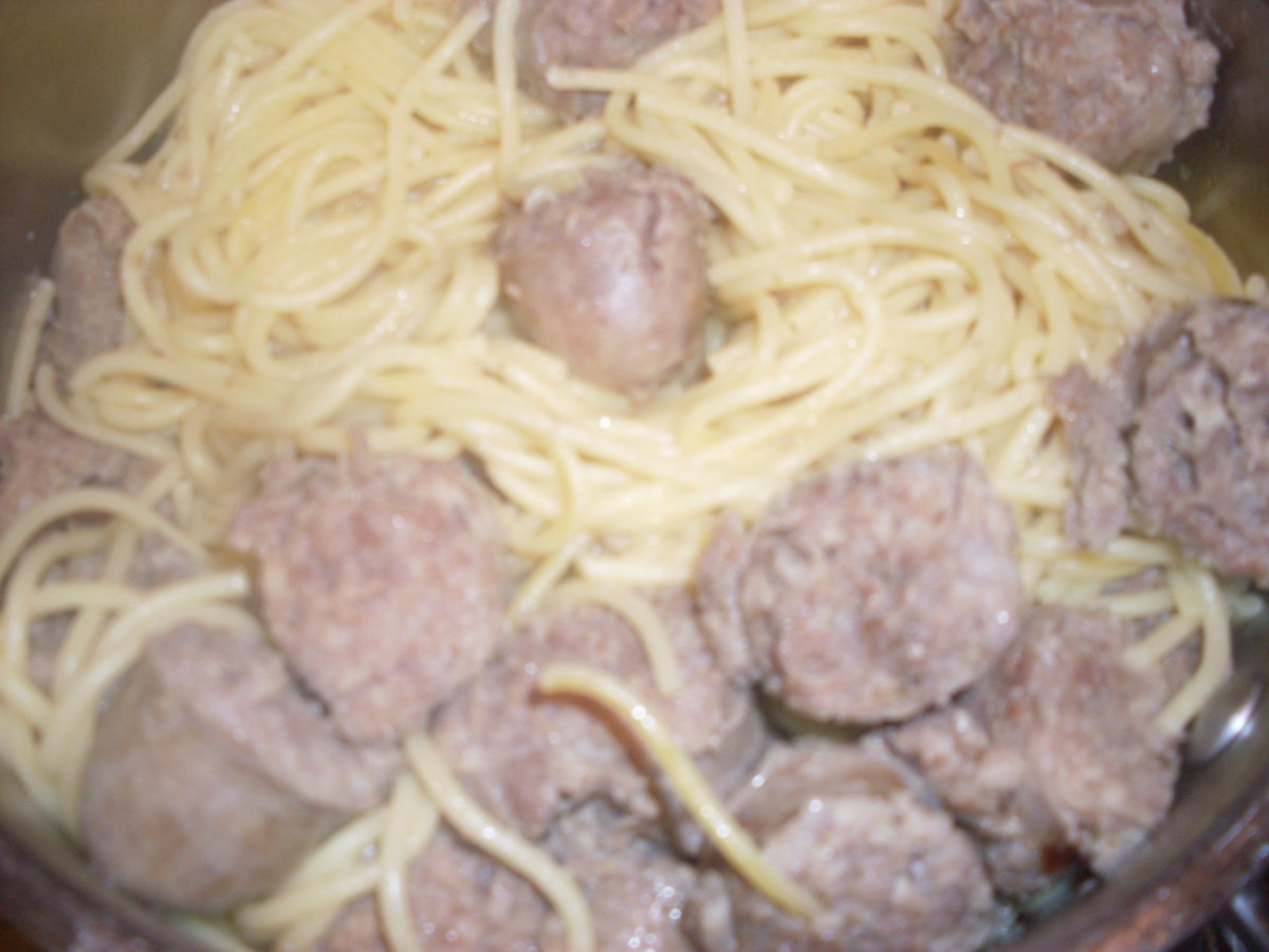 Thick, savory chunks of sliced sausage with tasty pasta, spaghetti specifically.
