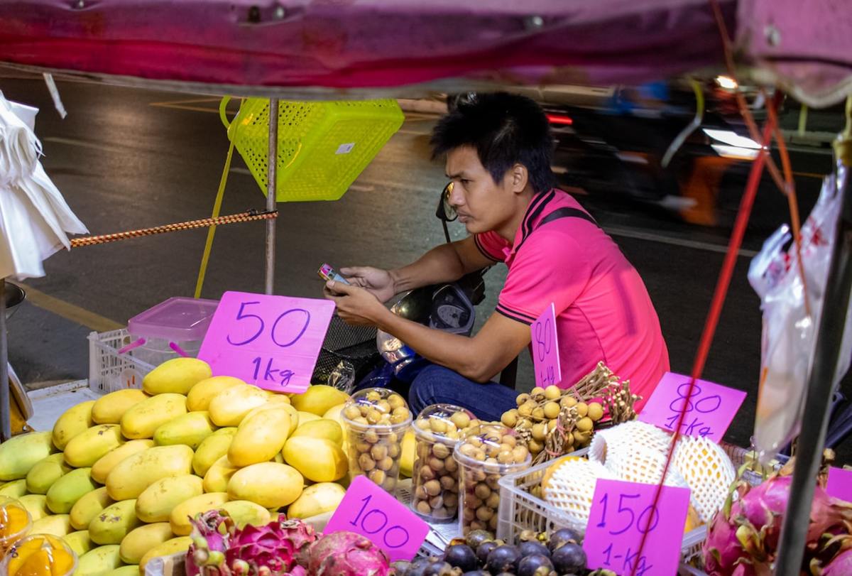 Fruit vendor (purple dragon fruit in foreground)