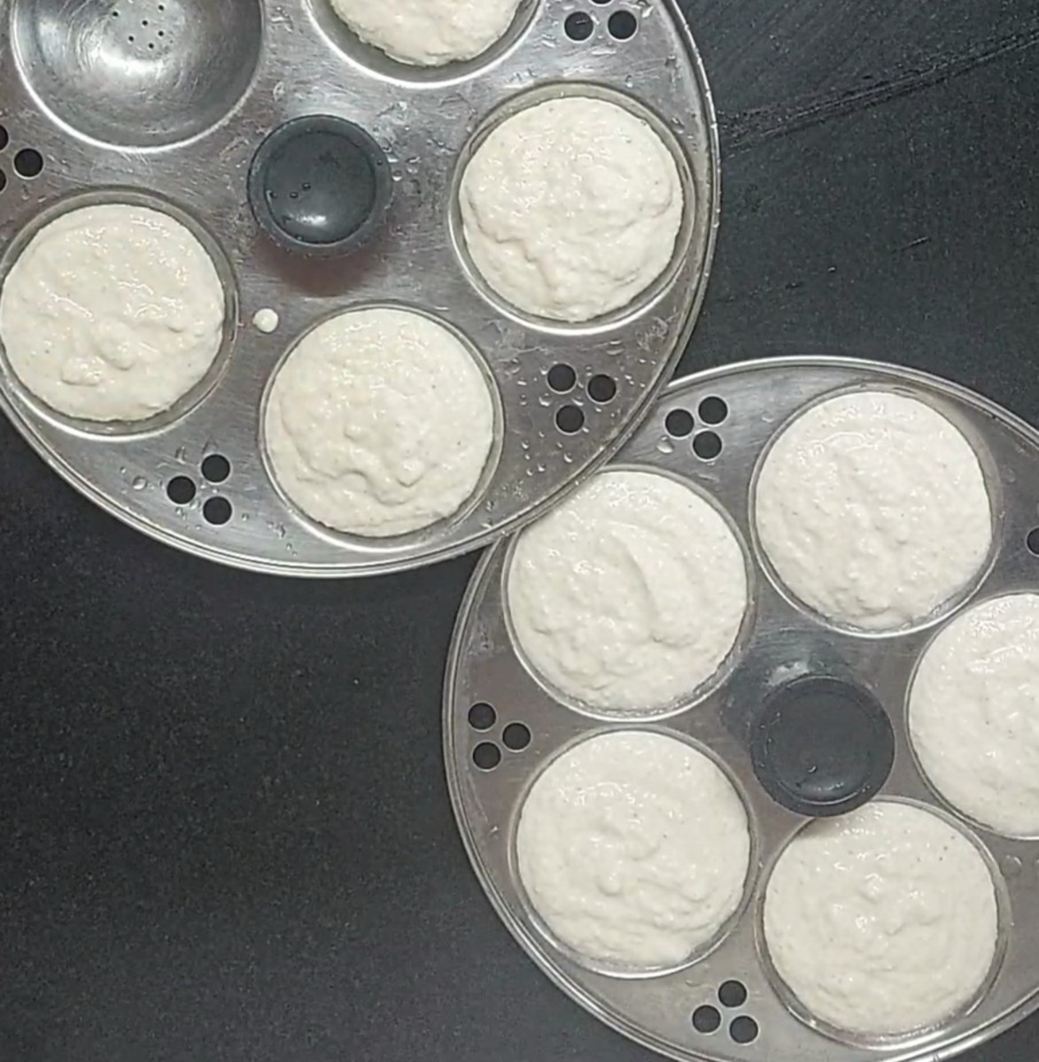 Add batter to the idli moulds, pat once.