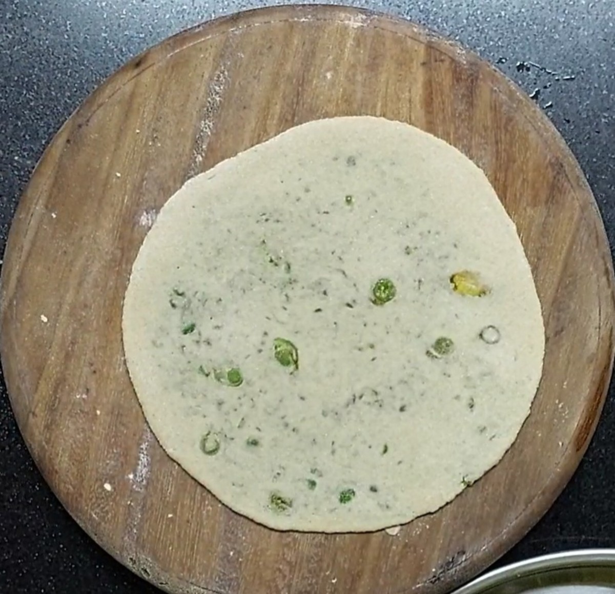 Sprinkle wheat flour and roll into medium thick paratha. Dust off excess flour if any.