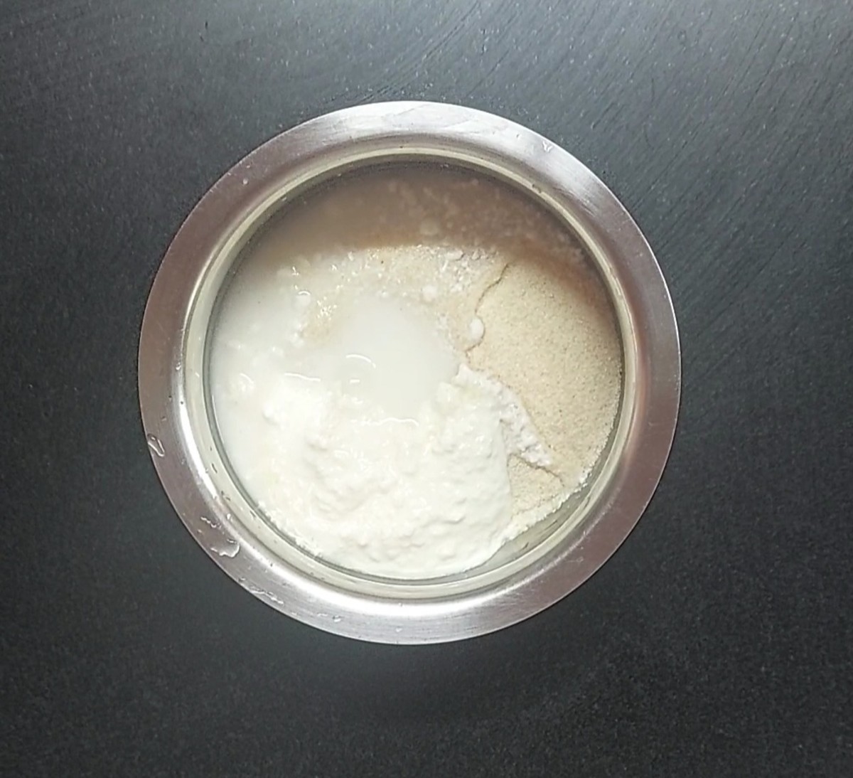 In a vessel, take 1 cup medium rava or bombay rava, 1/2 cup curd, 1/2 cup water.