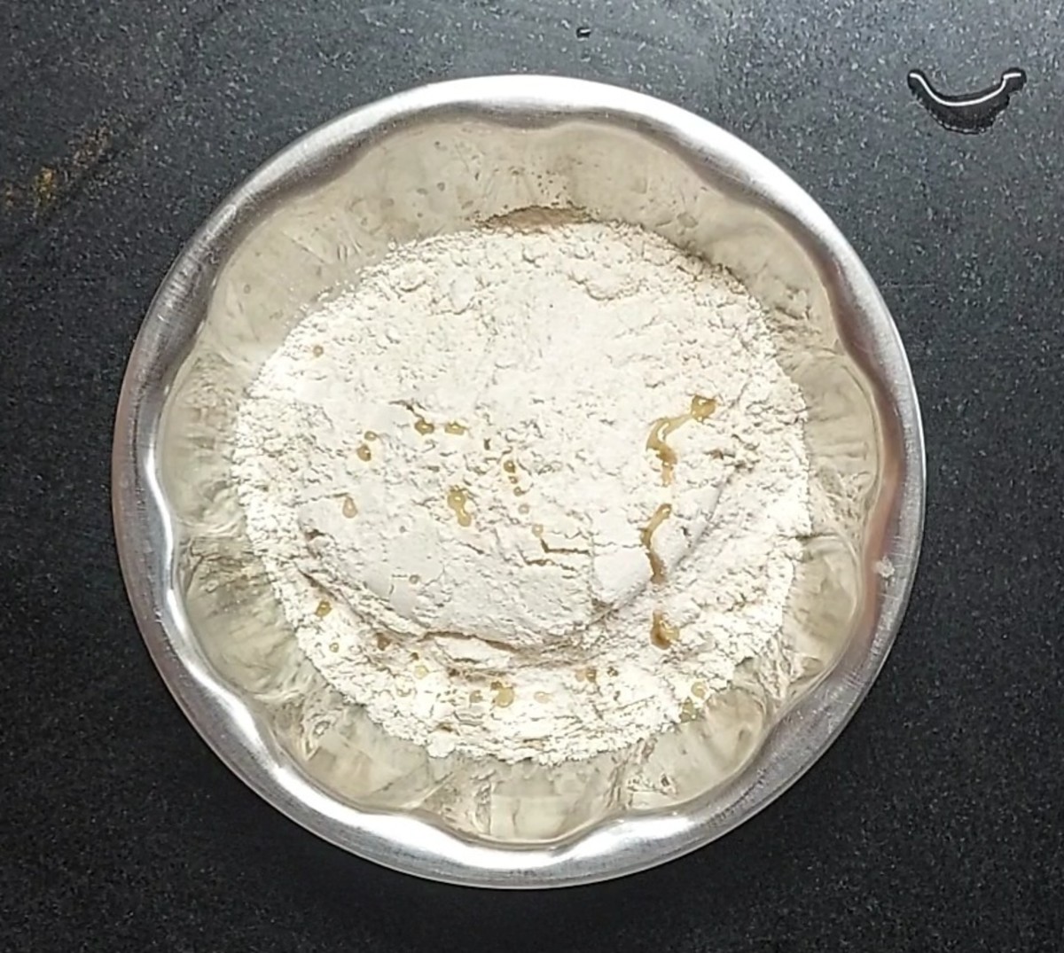 In a bowl, take 1 cup wheat flour, add salt, 1 teaspoon oil, mix well.