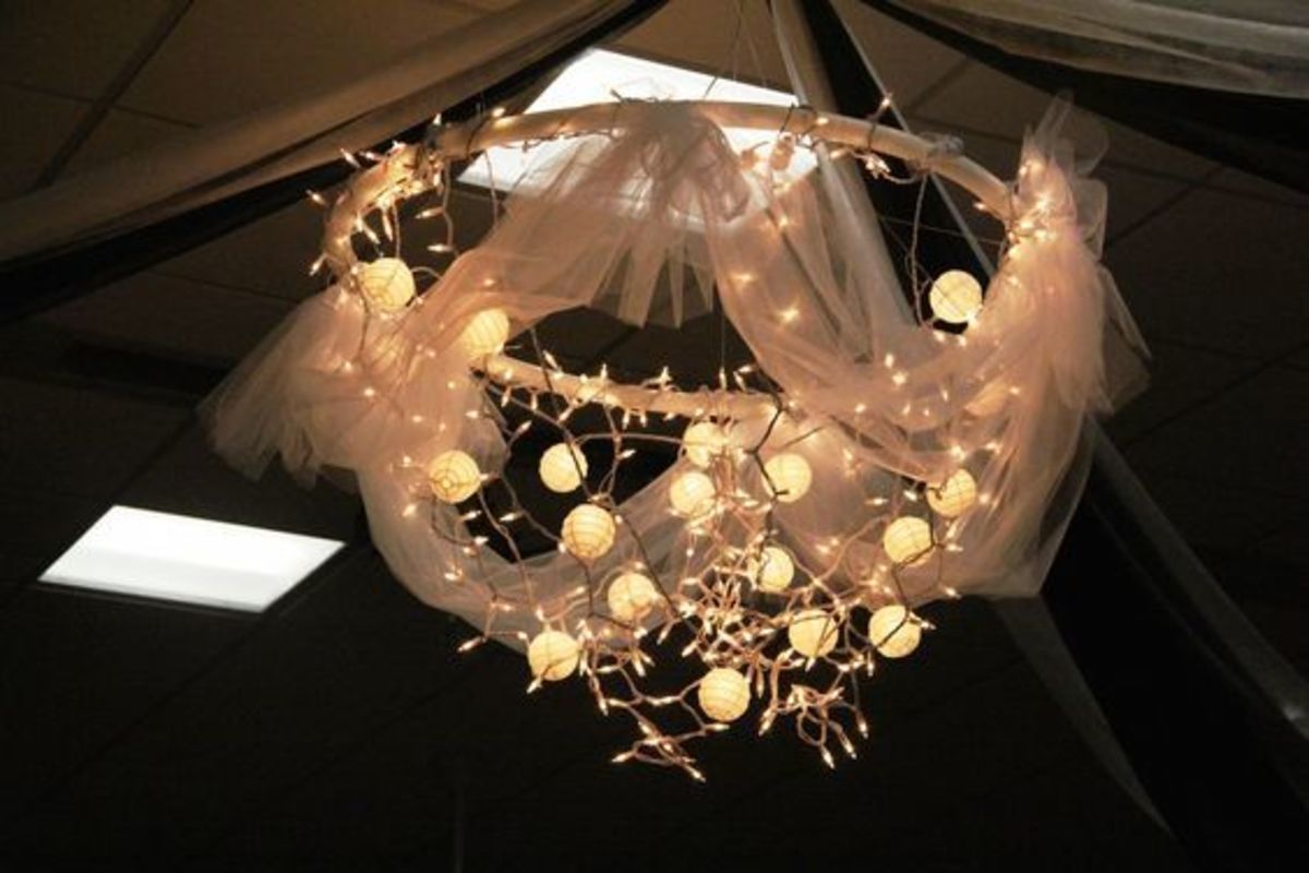 DIY Hula Hoop Chandelier - made out of a hula hoop, some string lights, and some tulle, and hang it using fishing line from the ceiling