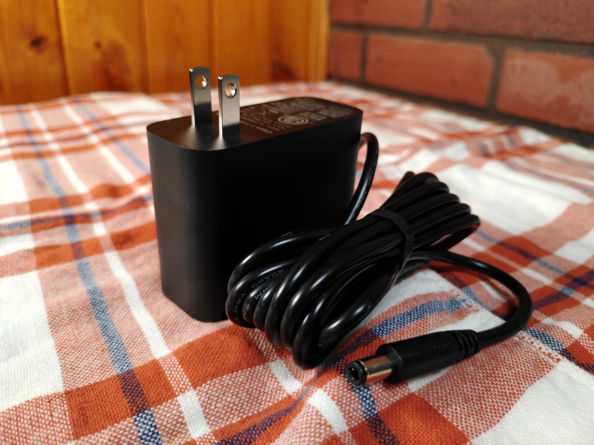 The AC adapter plugs into an input near the bottom of the fan