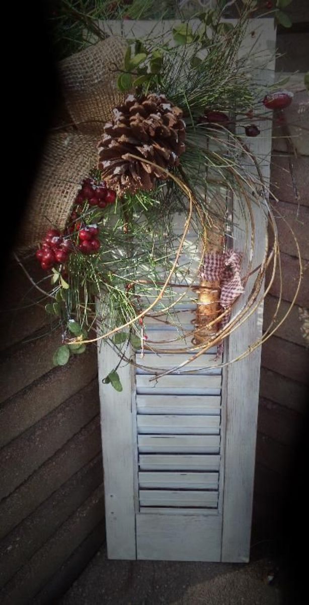Weathered Shutter With Evergreens and Pinecones