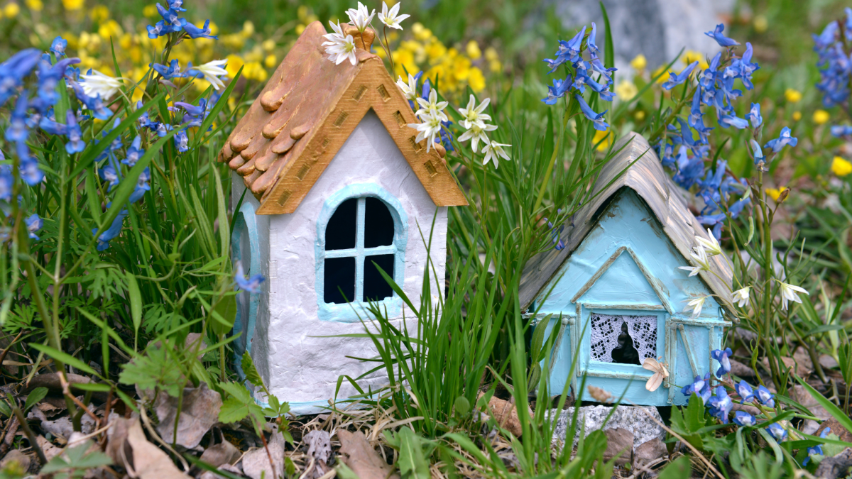 Pink and blue fairy houses in a garden
