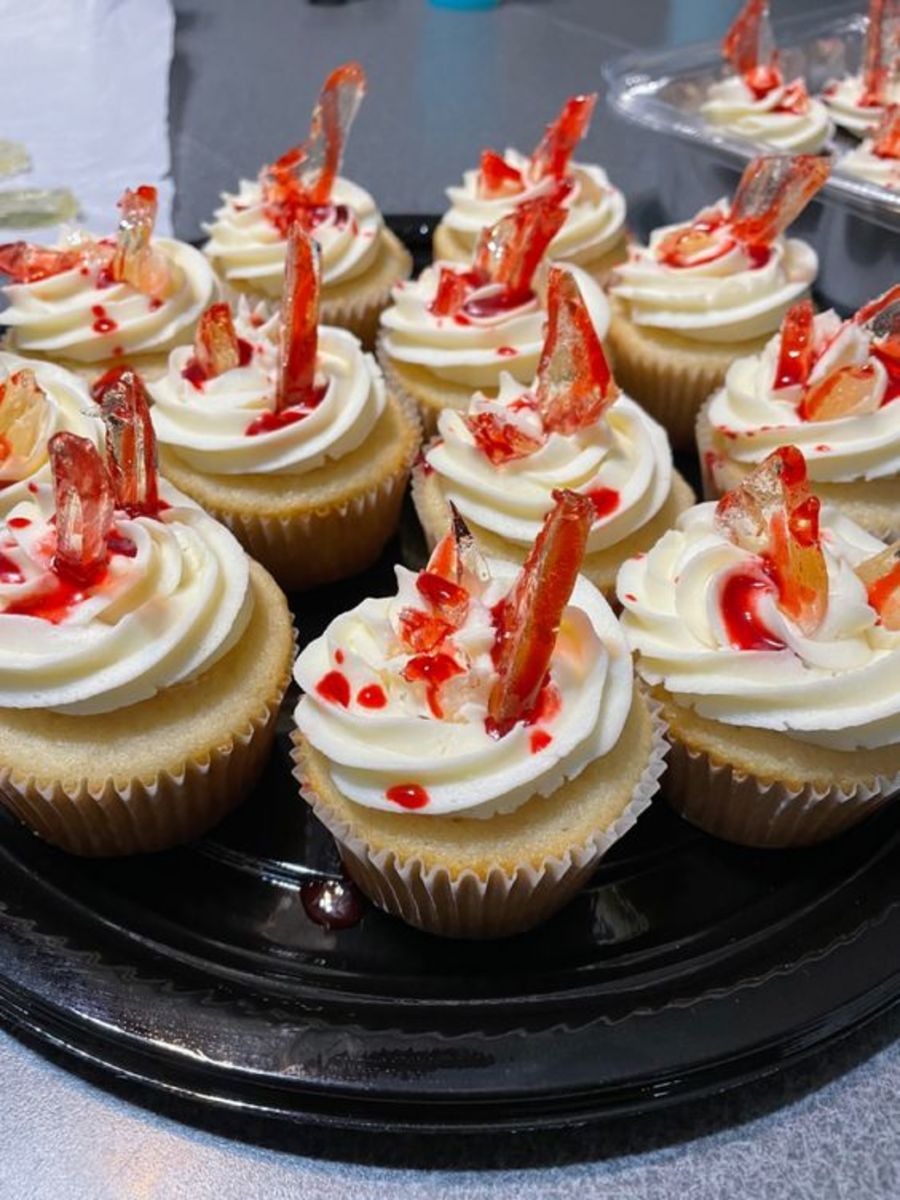 Bloody Broken Glass Cupcakes Buttercream icing with “broken glass” and “blood” decoration for a horror movie themed birthday party. The recipe for the "glass" is essentially one for caramel. 