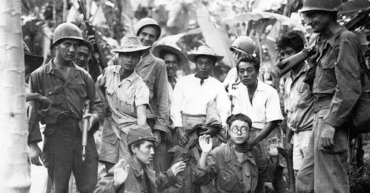 American and Filipino Guerillas with captured Japanese soldiers. 