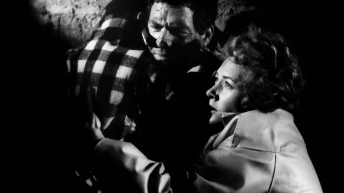 John (Paul Hubschmid) and Mary (Fiorella Mari) take shelter during the asteroid storm
