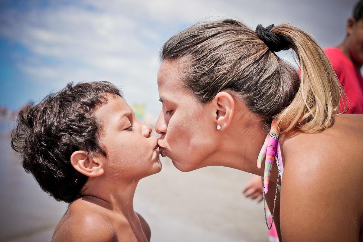 What are the benefits of kissing your child on the lips?
