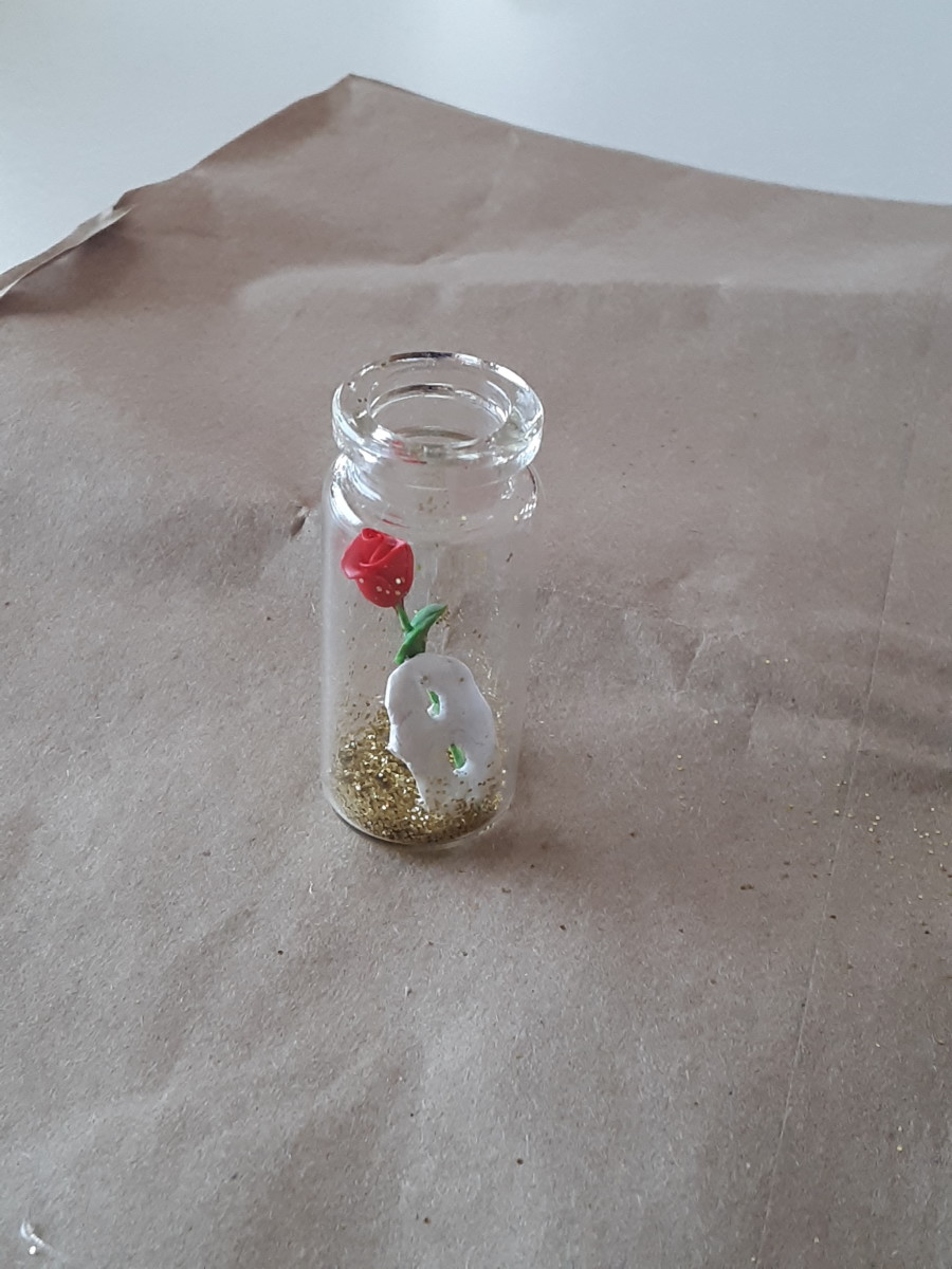 Put the mask and rose inside of jar.