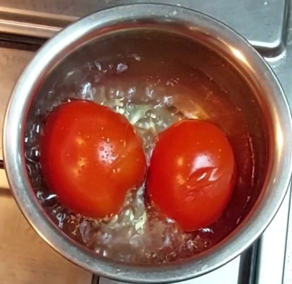 In a vessel, add 2-3 ripe tomatoes and 1 cup of water. Close the lid and cook till the skins start to split; then switch off the flame.