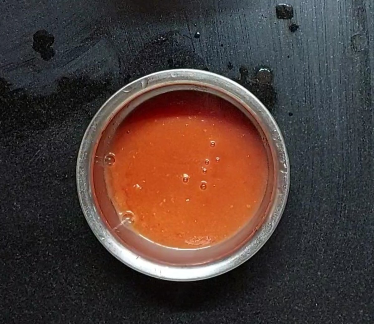 Transfer the peeled tomatoes to a mixer jar, close the lid and grind to a smooth paste. Tomato puree is ready. Set aside.
