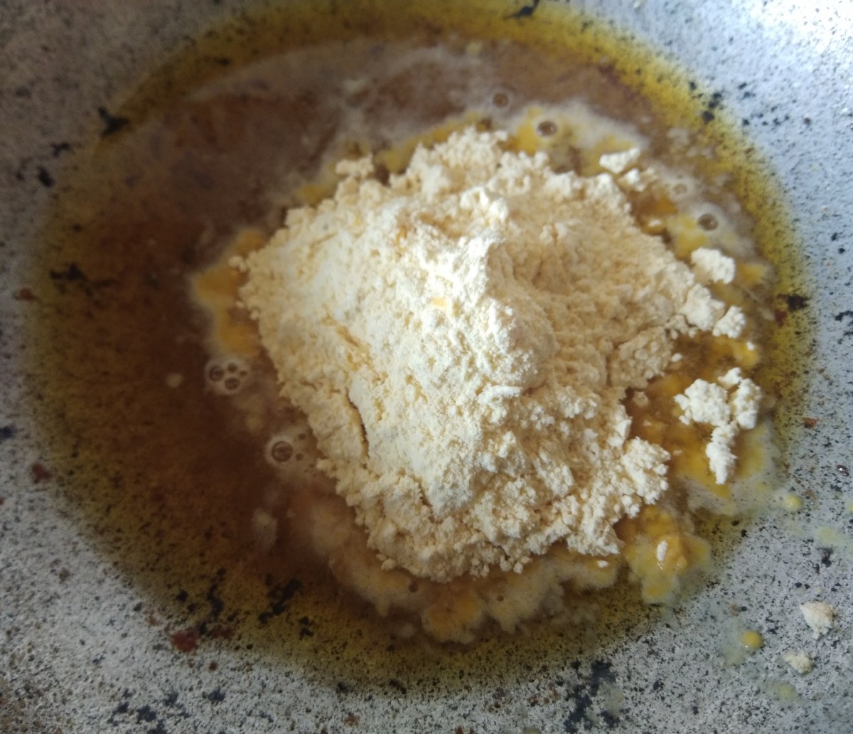 Measure one cup of gram flour and add to hot ghee.