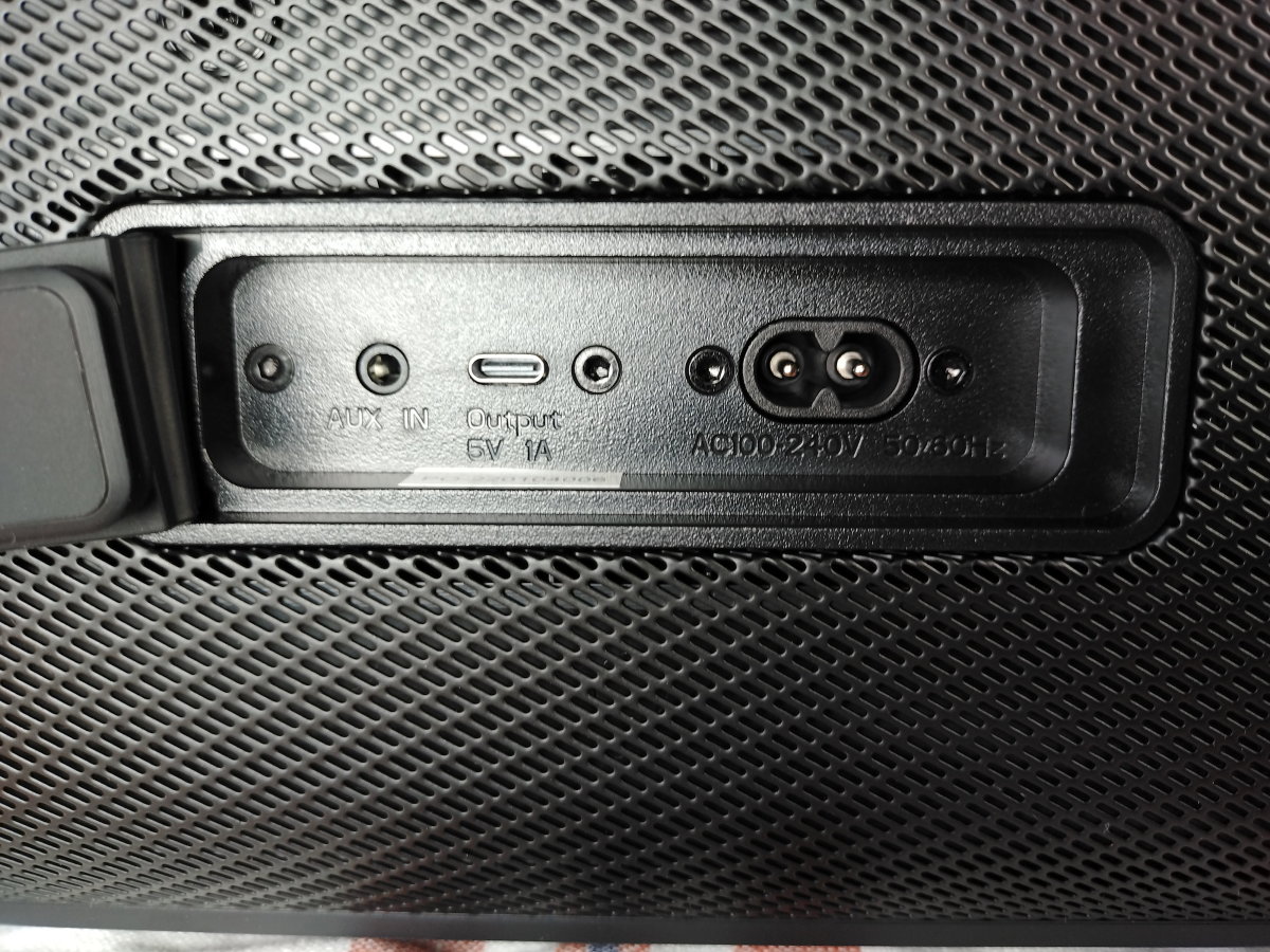 View of 3.5mm aux input, USB-C charging output, and charging input