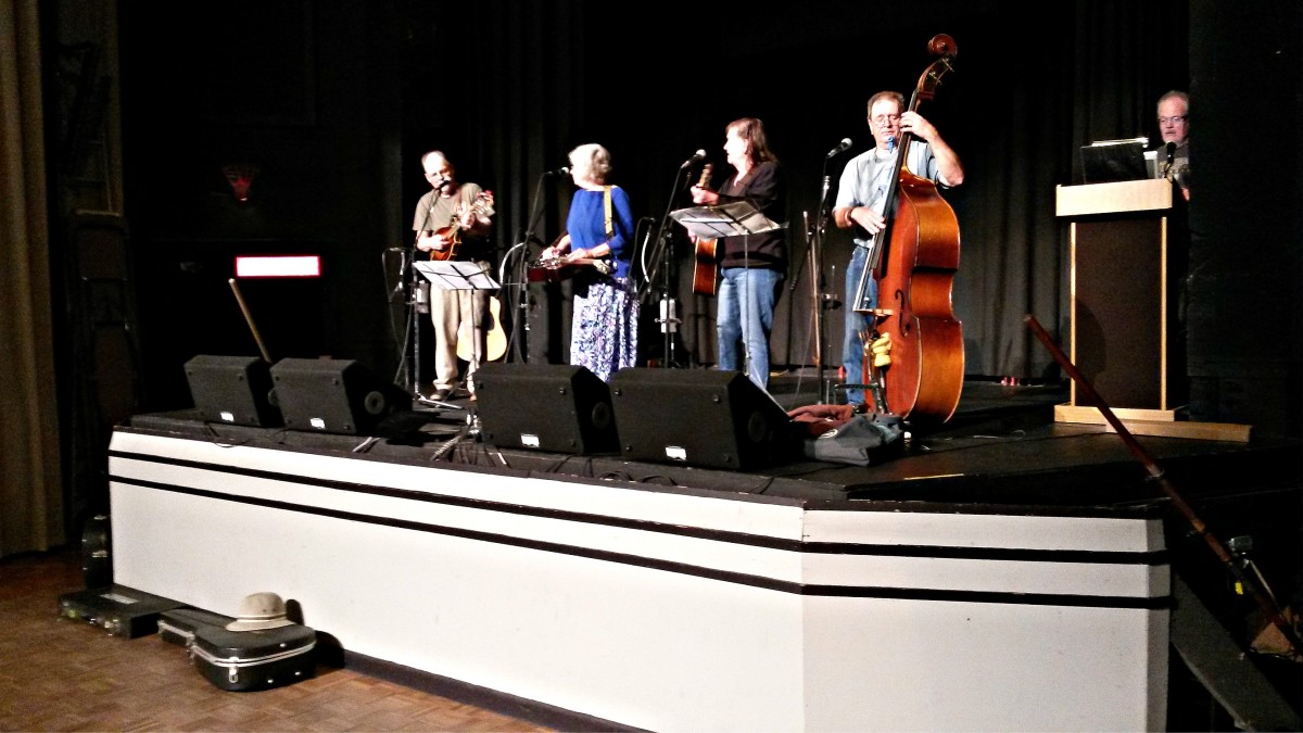 The F.A.R.M. T.E.A.M. performing live on the stage at the Earle Theater and broadcasting live over WPAQ radio.  Far right: Tim Chadwick, official host of the Merry Go Round.