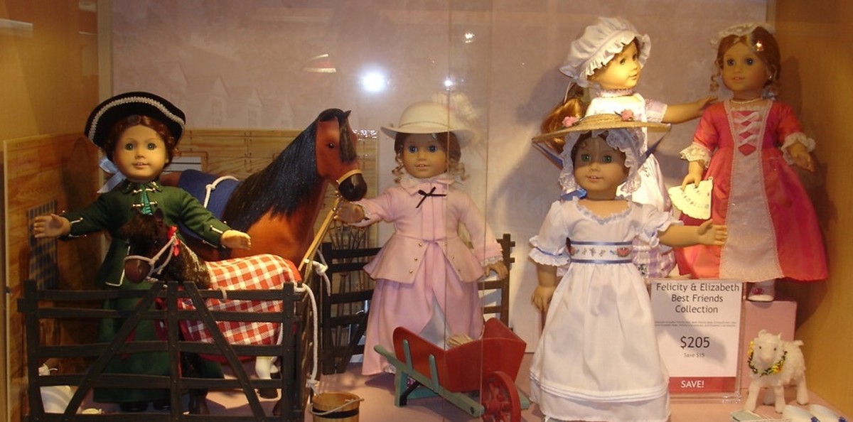 Elizabeth and Felicity dolls with items from their collections on display together at an American Girl Doll store.
