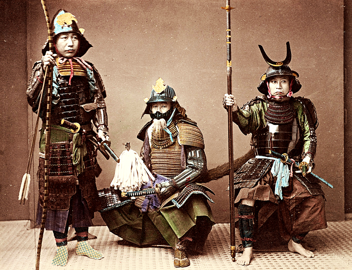Samurai in Armour, hand-coloured albumen silver print by Kusakabe Kimbei. Empire of Japan. The person on the left has a yumi (Japanese bow), the one in the center has a katana and the one on the right carries a yari (straight-headed spear).
