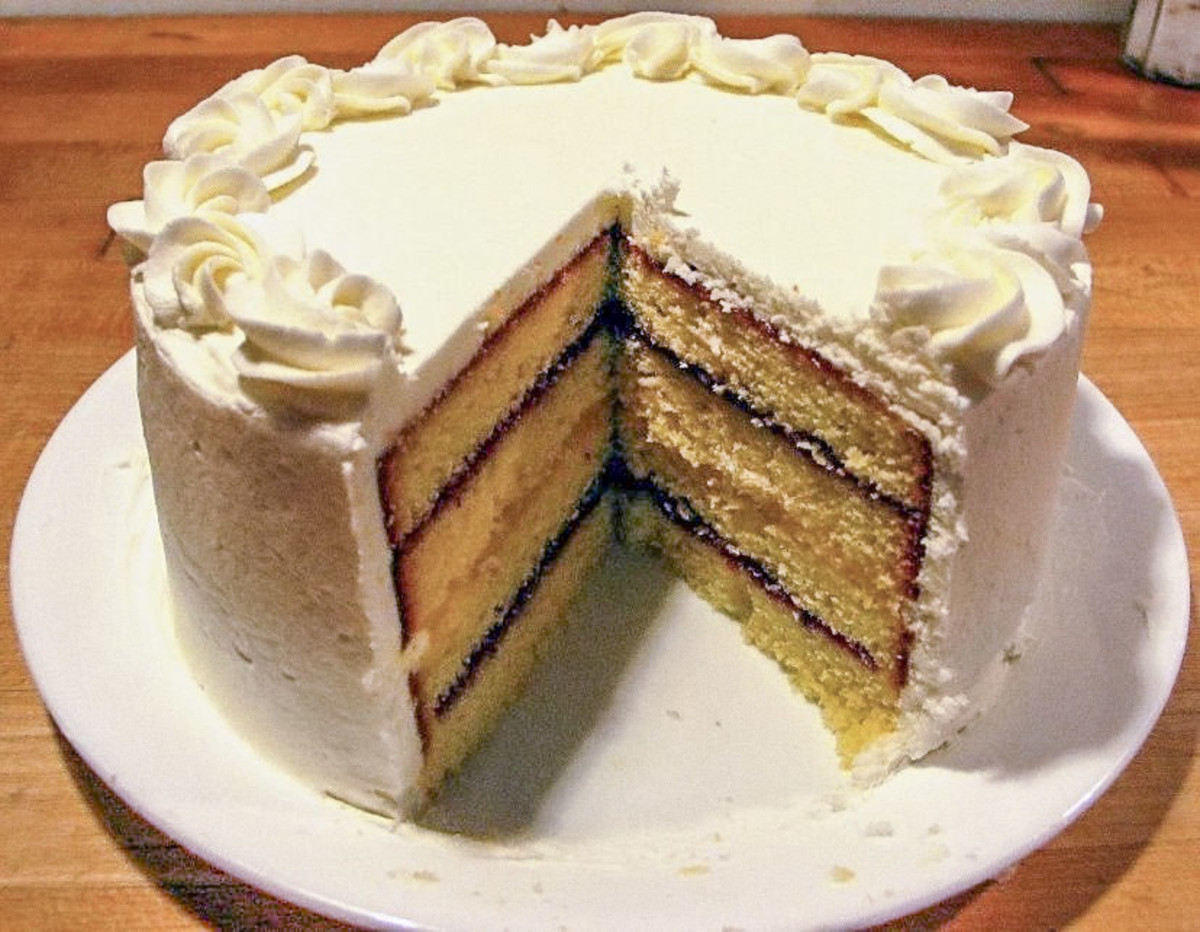 A layered pound cake with a piece missing.
