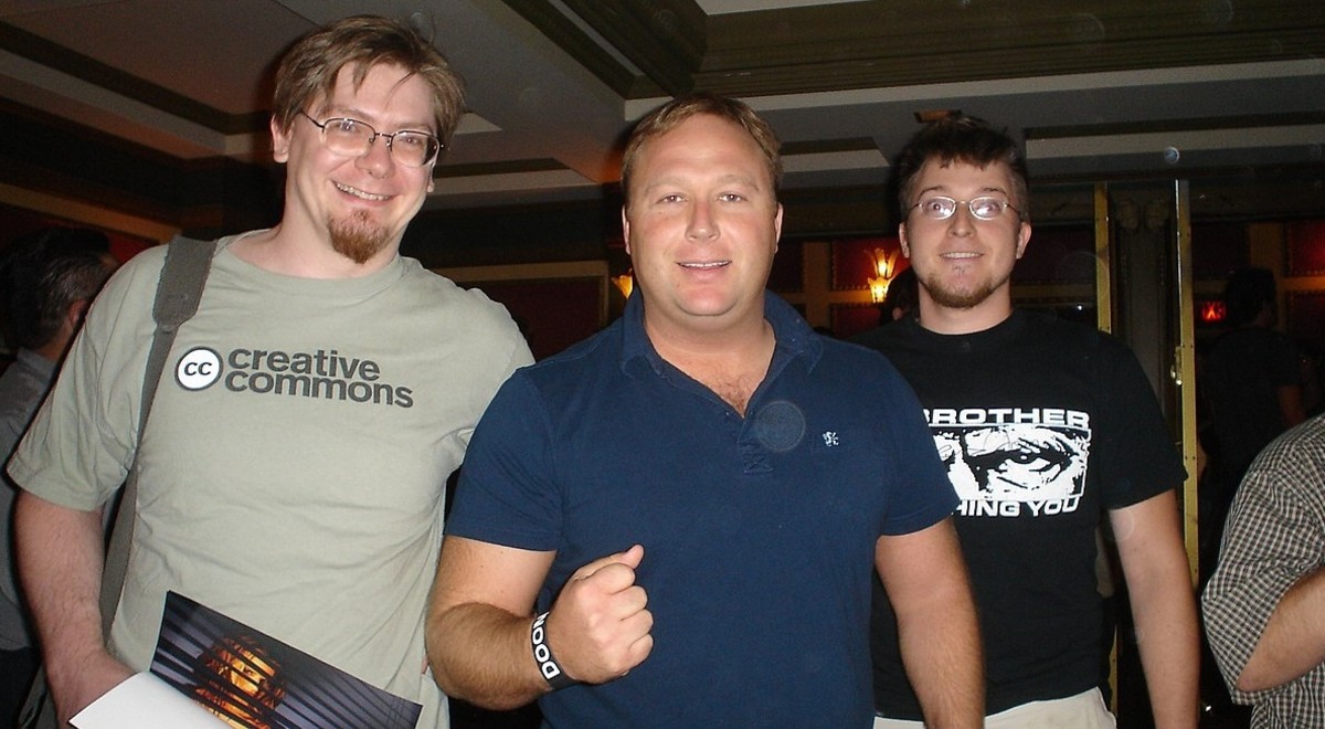 The popular conspiracy theorist, Alex Jones (center), has been branded a fake or a "double agent" by some of his followers.