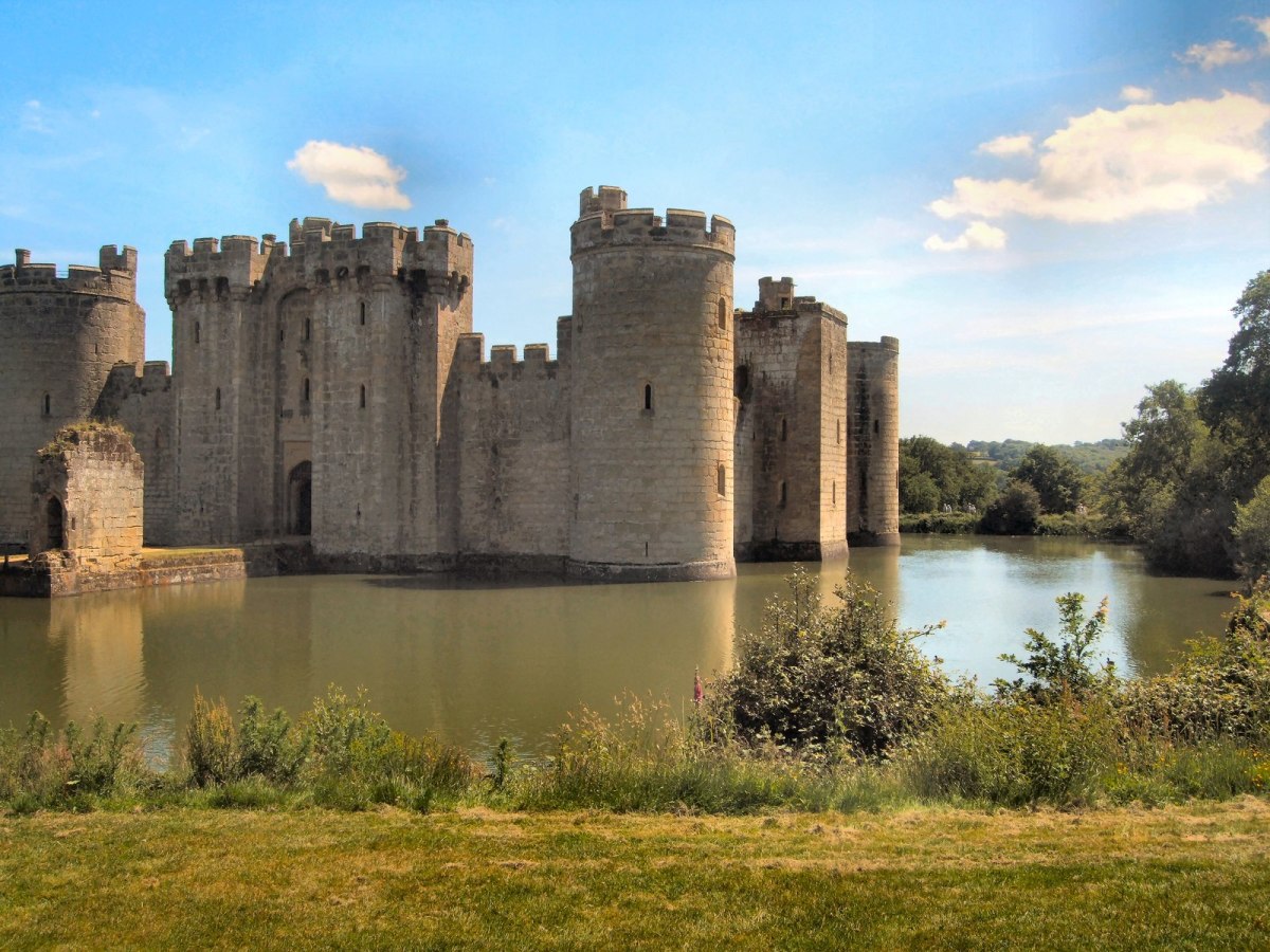 Bodiam Castle and Moat in Robertsbridge, United Kingdom. It was built to defend the area against a French invasion during the Hundred Years' War.