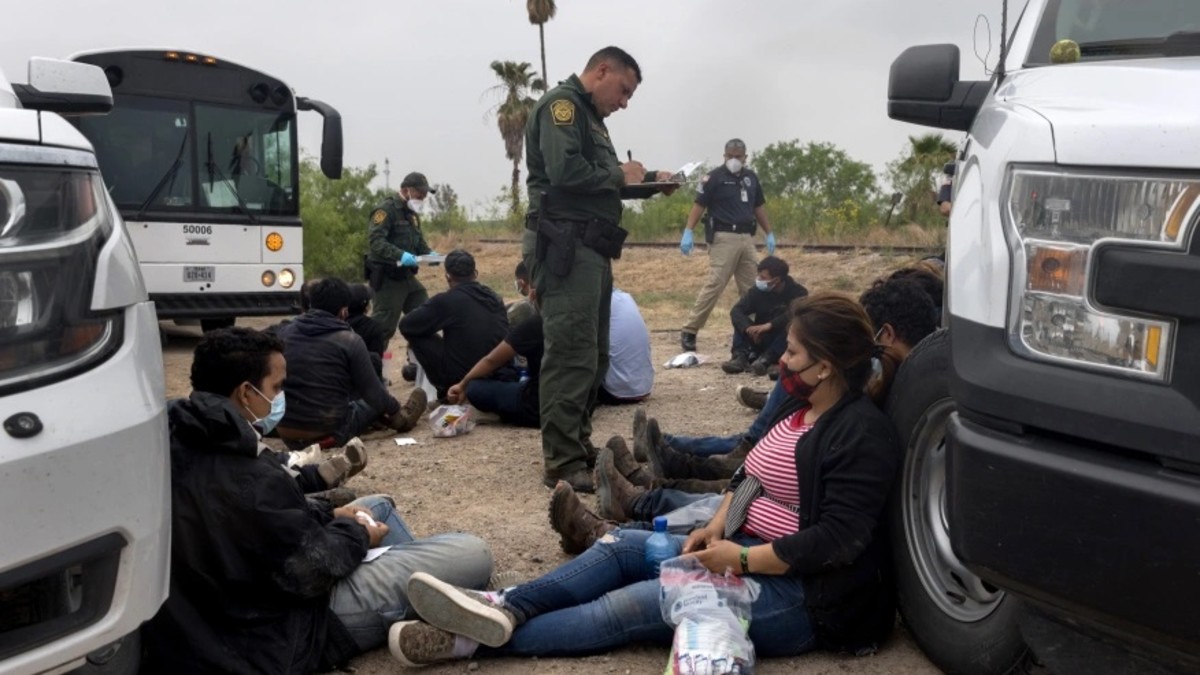 A U.S. Border Patrol agent registers immigrants before bussing them to a processing center near the U.S.-Mexico border on April 13, 2021, in La Joya, Texas.