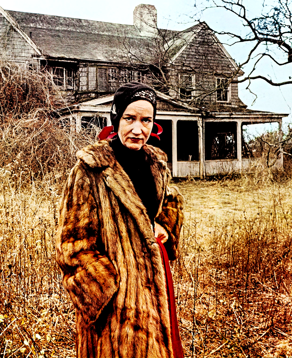 Edith "Little Edie" Bouvier Beale in front of Grey Gardens.