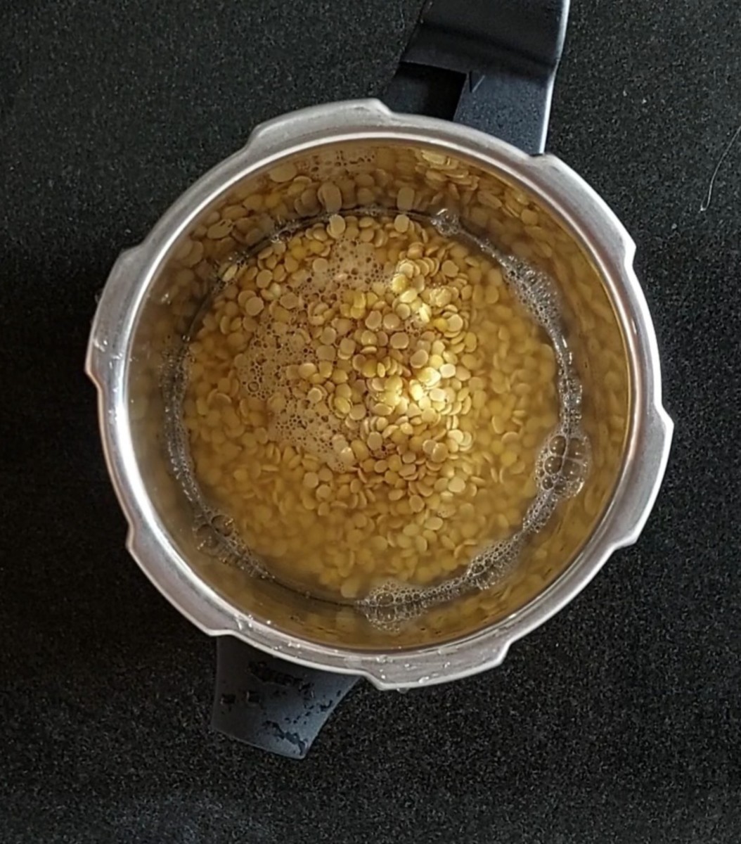 Transfer soaked toor dal to a cooker (along with soaking water), add 1/2 tablespoon oil, close the lid and take 3 whistles or till dal is cooked well. Let the pressure of the cooker subsides on its own.