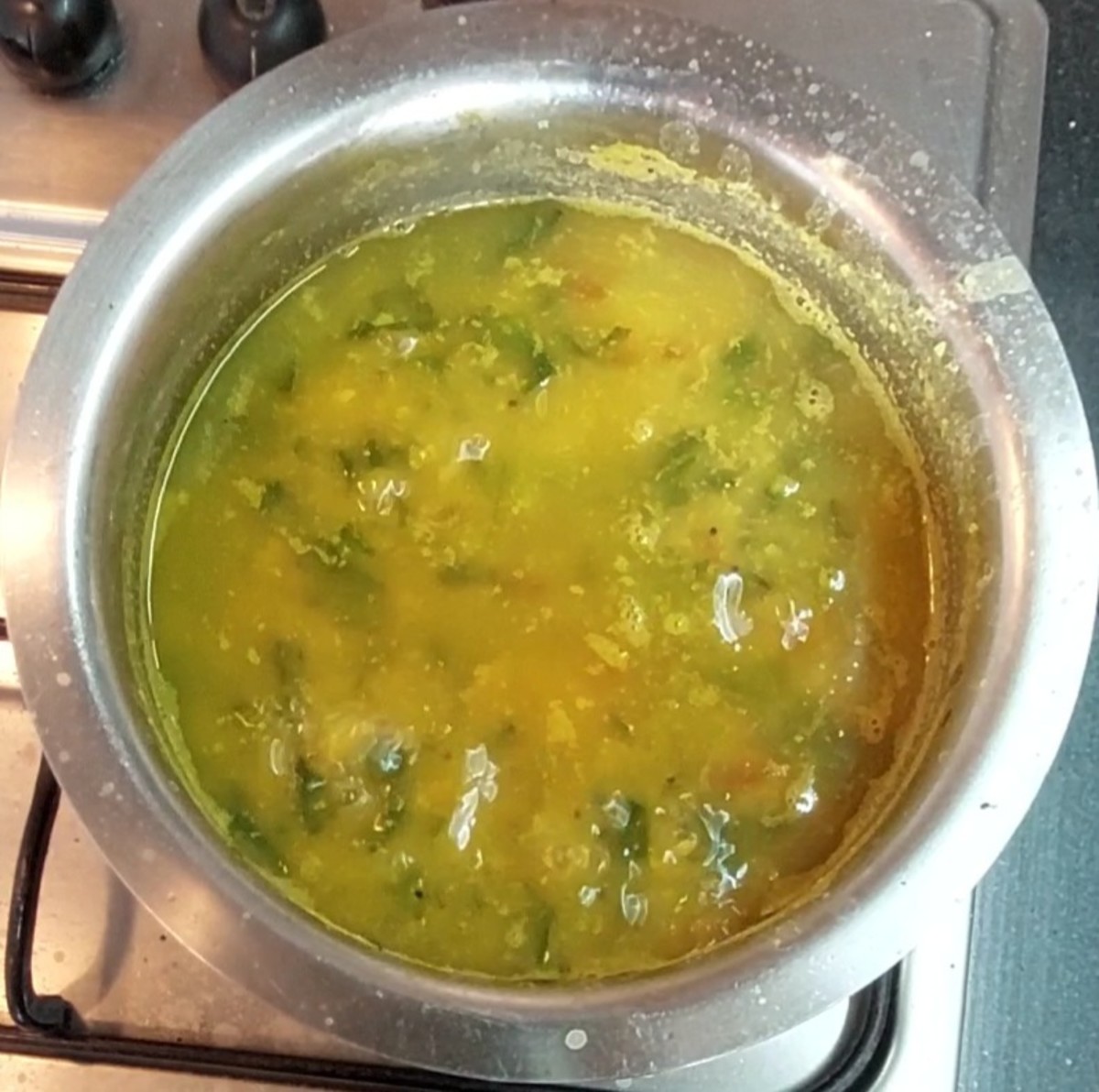 Add cooked dal and 1/2 cup water. Mix well. Add more water if required to adjust the consistency. Add salt to taste. Close the lid and cook for 10 minutes or till palak is cooked well.