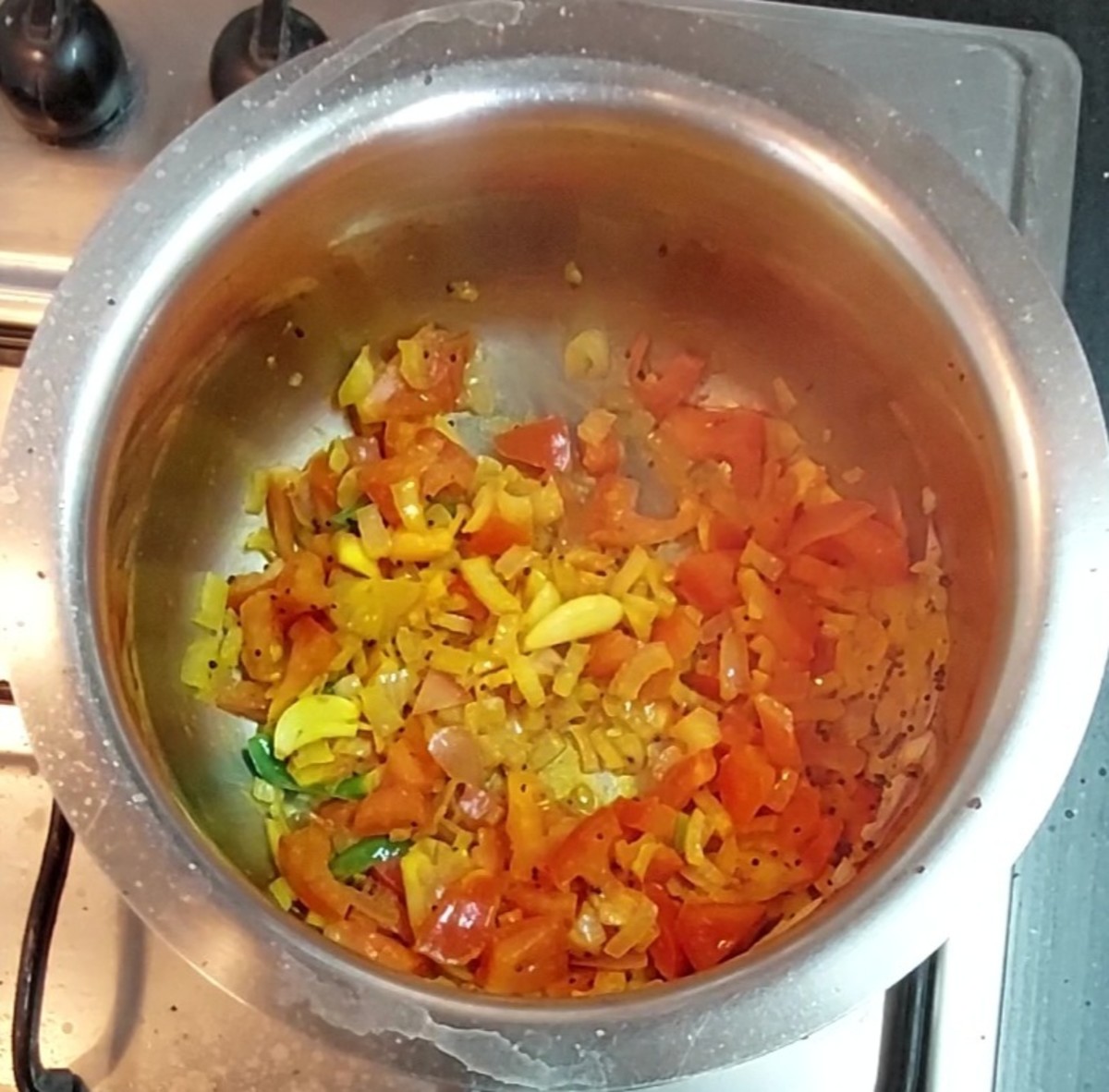 Add 1 cup chopped tomato and 1/2 teaspoon turmeric powder. Saute till tomato shrinks.