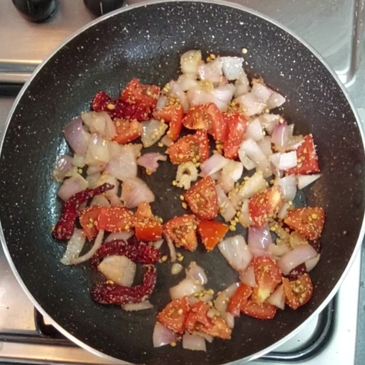 Add 1 cup chopped tomato and saute till it shrinks.