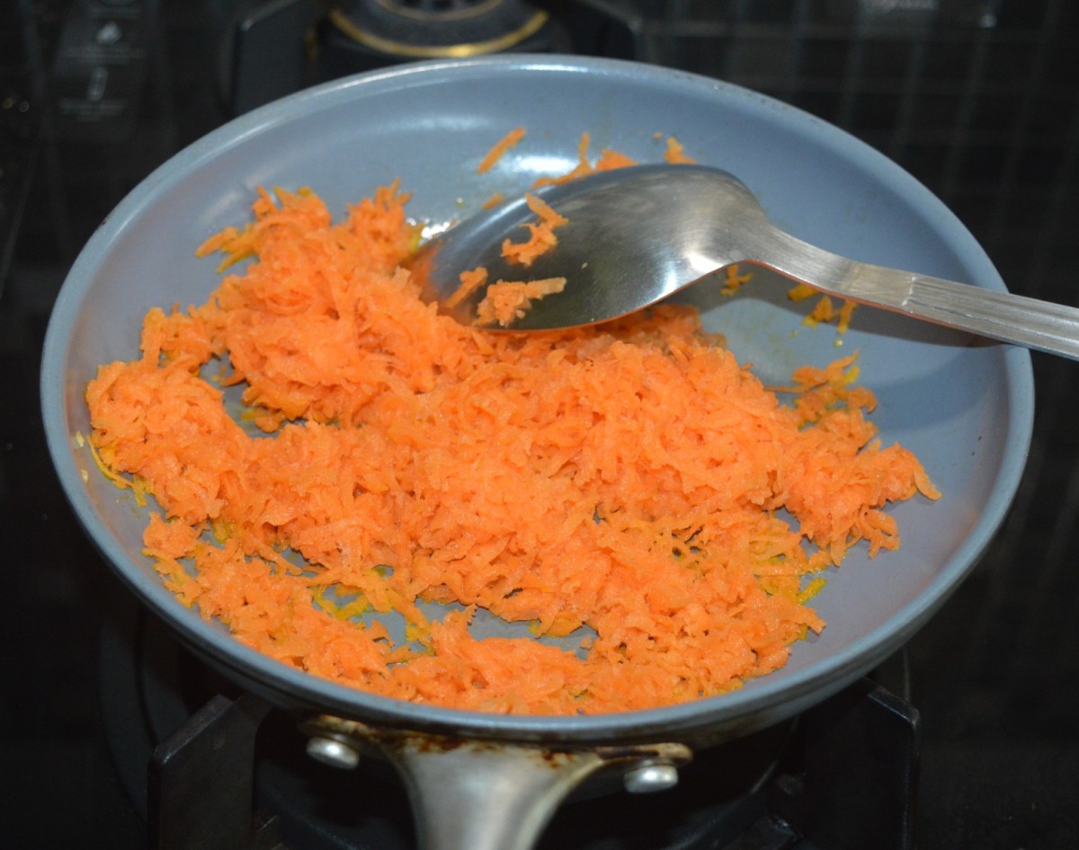 Step four: Add grated carrots to the same pan.