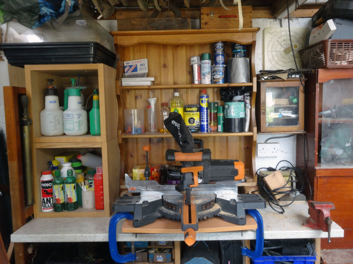 shelving unit modified and metal vice relocated to fit the mitre saw on it's bespoke platform comfortably on the workbench.