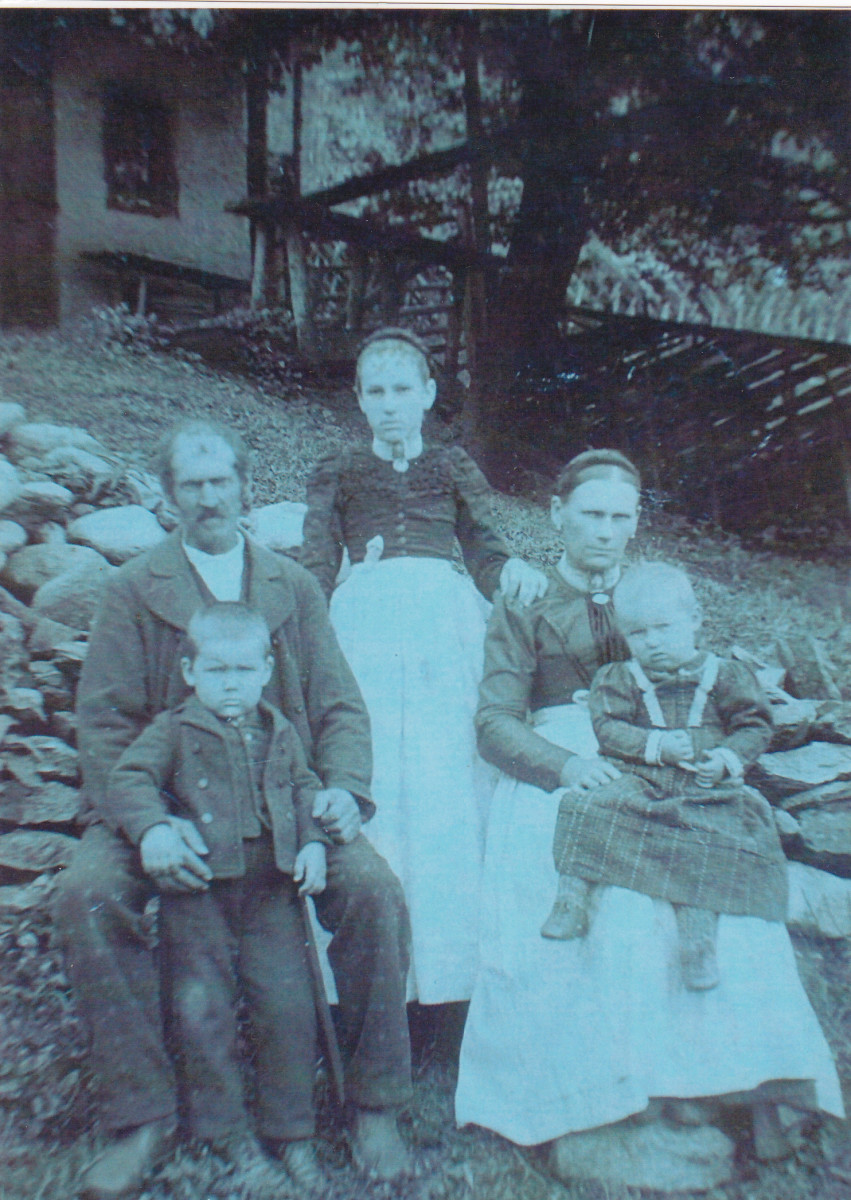 My paternal grandma at about age of 13 in Austria around 1890. She is with her father, step-mother, and half-sister and half-brother.