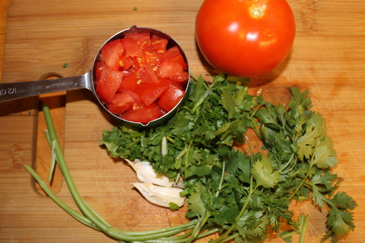 Chop up the tomato, cilantro, and garlic. Add them in the blender.