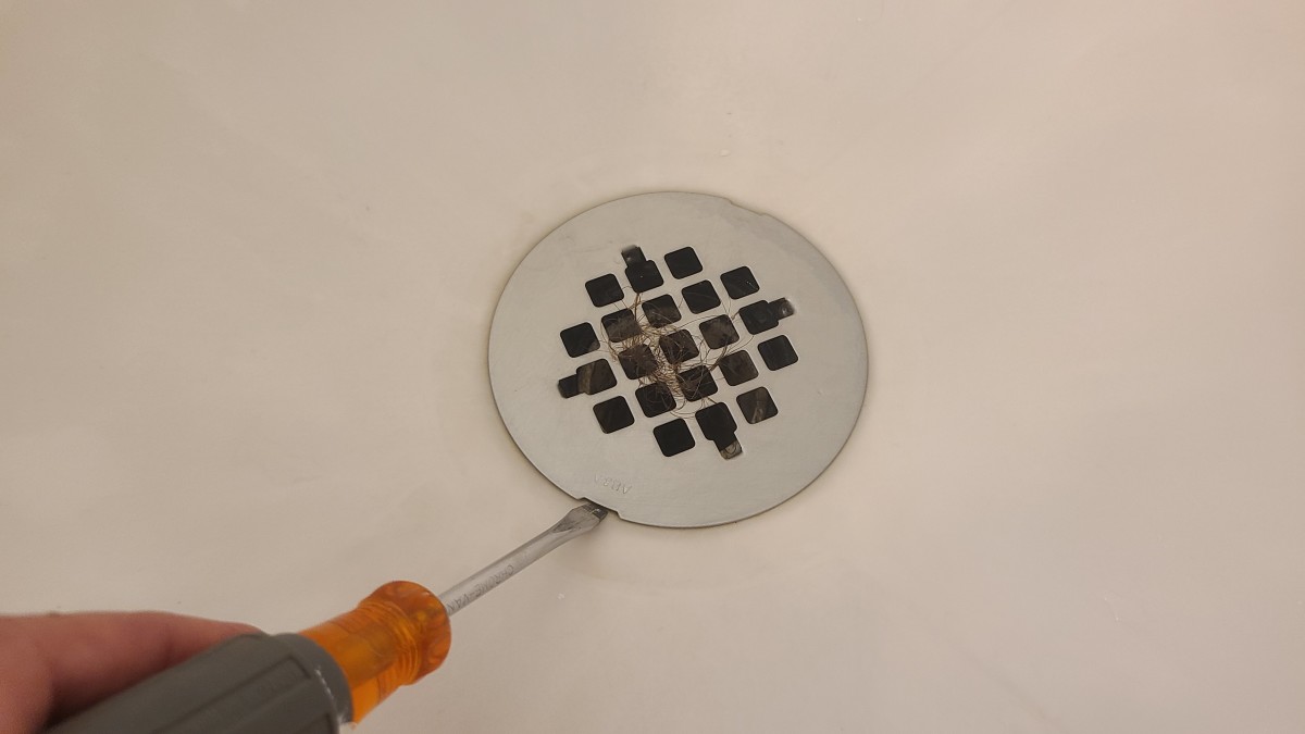 The first step to unclogging a shower drain is to remove the drain cover.