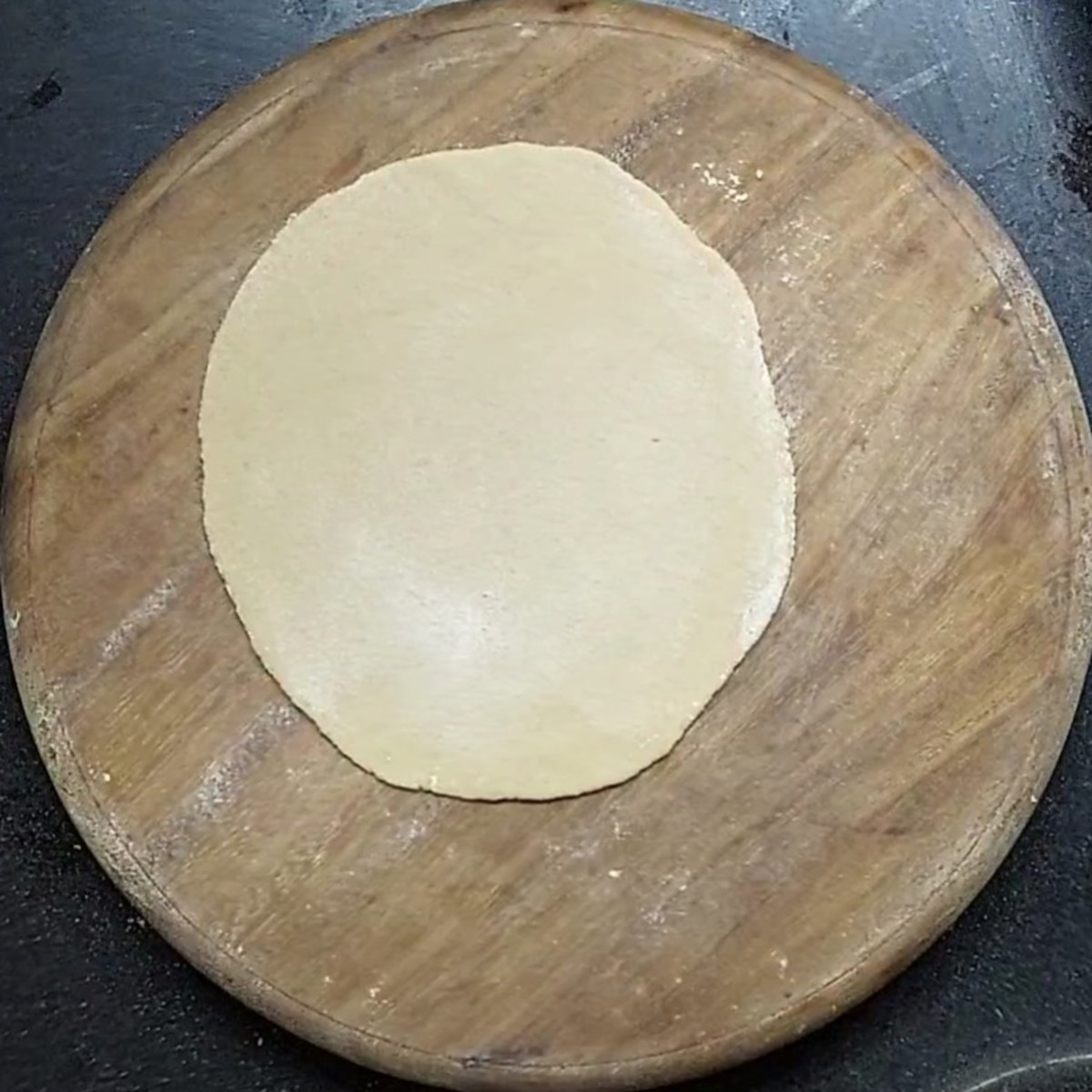 Prepare balls from the dough. Take a ball on the rolling board, sprinkle some wheat flour and roll it into a chapati.