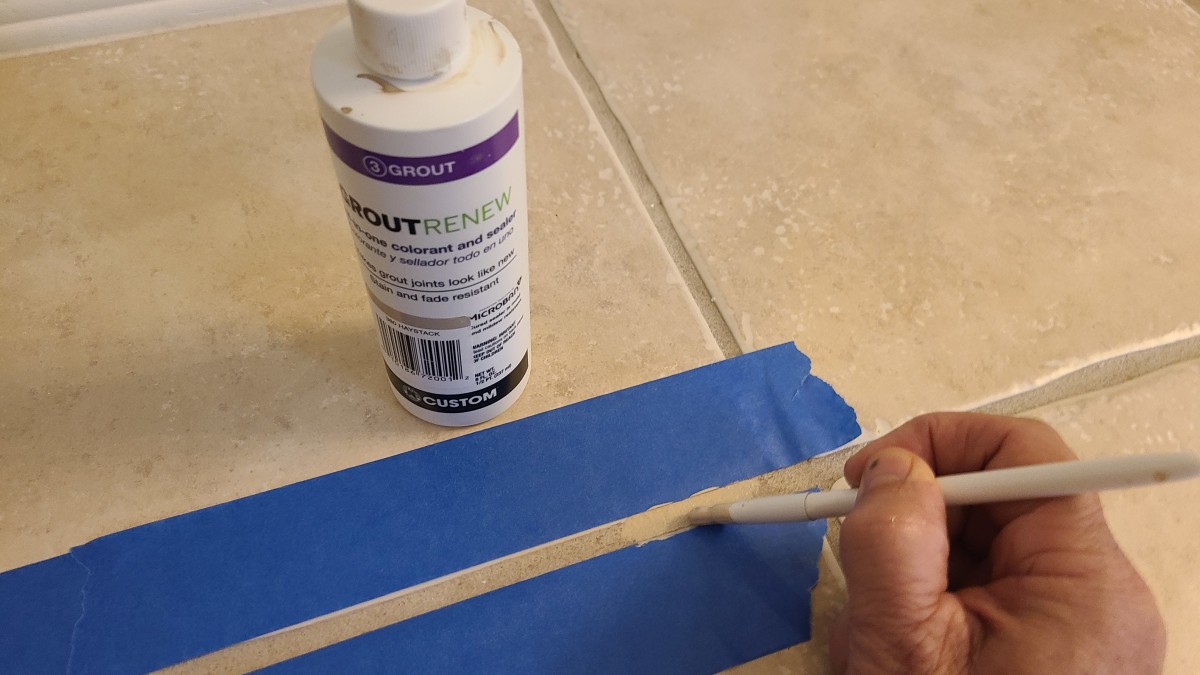 Painter's tape can help you keep grout paint off of the tiles.