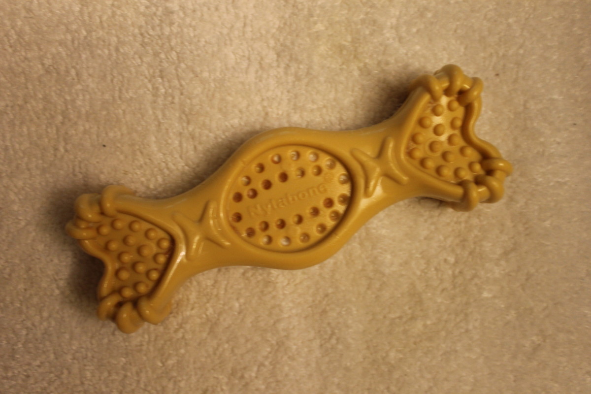This non-edible Nylabone chew is made of nylon. I scrape peanut butter and yogurt on it and freeze it for my dog to lick.