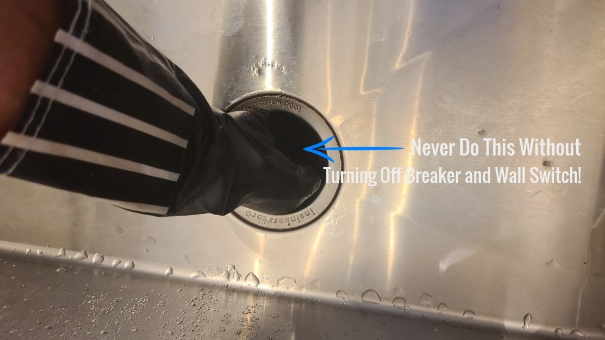 Never stick your hand in a garbage disposal without turning off the breaker or unplugging it, and making sure wall switch is off!