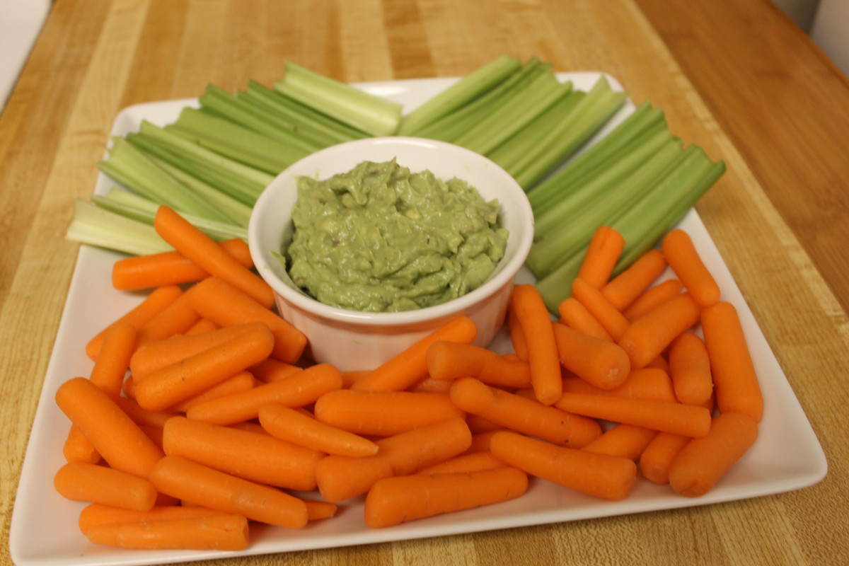 Enjoy this guacamole dip with fresh veggies for a healthy snack.