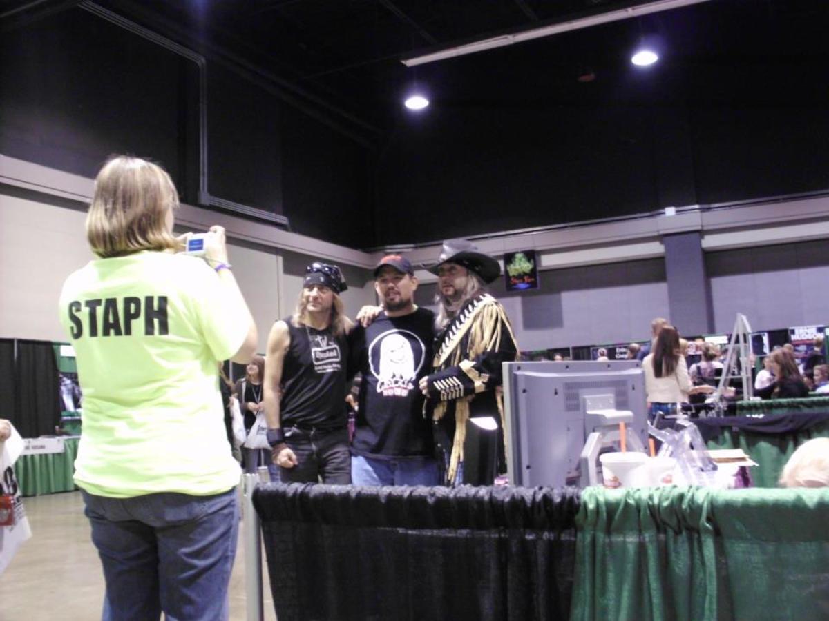 STAPH member assisting with photos for a fan.