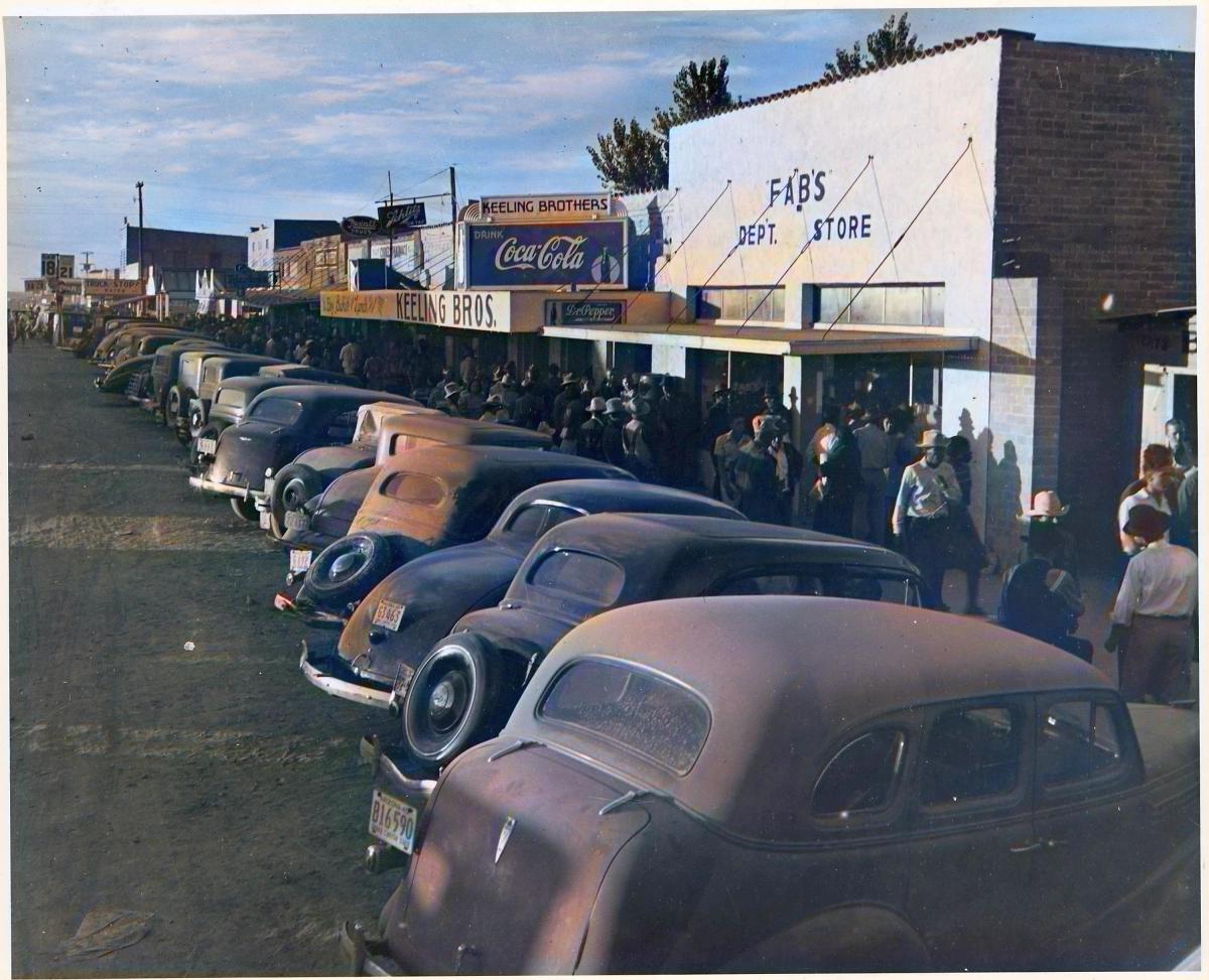 Eloy, Pinal County, Arizona. Crowds of cotton pickers on main street of Eloy late Saturday afternoon. (colorized using DeOldify)
