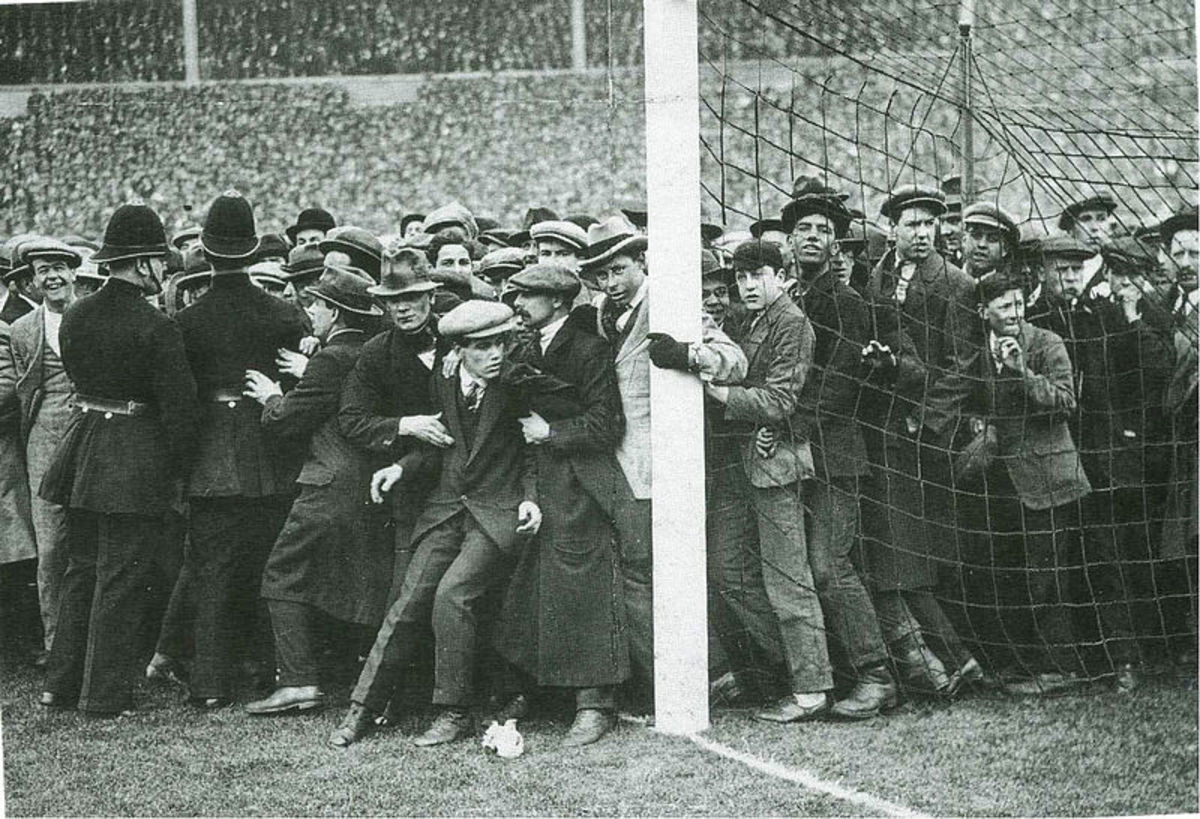 Supporters flood the pitch in the 1923 F.A. Cup final.