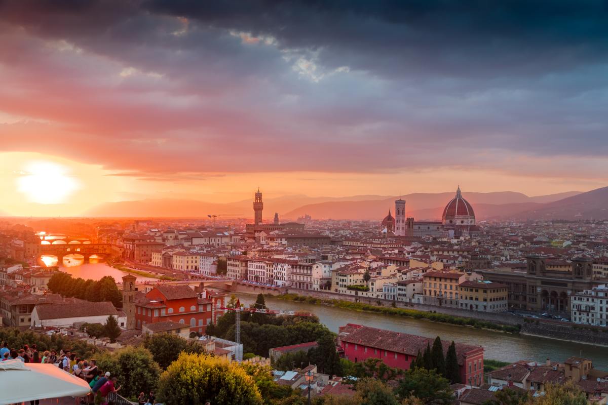 Sunset view of Florence featuring Ponte Vecchio, Palazzo Vecchio, and the Duomo.  