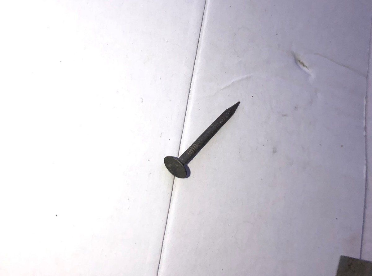 This drywall nail has a concave head.